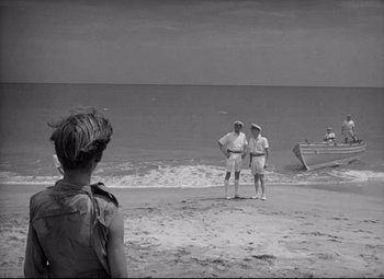 Movie still from “Lord of the Flies” (1963), directed by Peter Brook – Two men standing on the beach looking out at the ocean; Wide shot, High angle