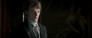 Movie still from “Lost Illusions” (2021), directed by Xavier Giannoli – A young man in a suit and a white bow tie; Close Up shot, Over the shoulder angle