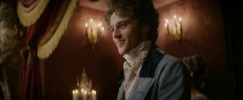 Movie still from “Lost Illusions” (2021), directed by Xavier Giannoli – A young man in a suit and tie; Close Up shot, Over the shoulder angle