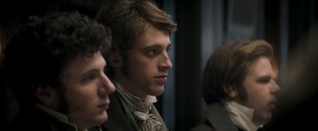 Movie still from “Lost Illusions” (2021), directed by Xavier Giannoli – A young man in a bow tie looks to his left; Close Up shot, Over the shoulder angle