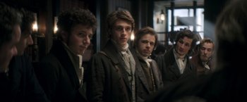 Movie still from “Lost Illusions” (2021), directed by Xavier Giannoli – A group of young men standing next to each other; Medium shot, Over the shoulder angle