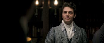 Movie still from “Lost Illusions” (2021), directed by Xavier Giannoli – A man in a suit and tie standing in a room; Close Up shot, Over the shoulder angle