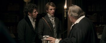 Movie still from “Lost Illusions” (2021), directed by Xavier Giannoli – Two men in period clothing talking to another man in a suit; Medium shot, Over the shoulder angle