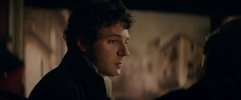 Movie still from “Lost Illusions” (2021), directed by Xavier Giannoli – A person with curly hair; Close Up shot, Over the shoulder angle