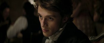 Movie still from “Lost Illusions” (2021), directed by Xavier Giannoli – A person wearing a suit and tie; Close Up shot, Over the shoulder angle