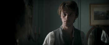 Movie still from “Lost Illusions” (2021), directed by Xavier Giannoli – A young man is looking at the camera; Close Up shot, Over the shoulder angle