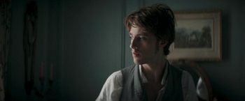 Movie still from “Lost Illusions” (2021), directed by Xavier Giannoli – A young man is looking into the distance; Close Up shot, Over the shoulder angle