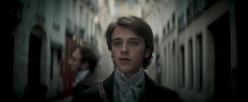 Movie still from “Lost Illusions” (2021), directed by Xavier Giannoli – A young man in a suit and a tie; Close Up shot, Low angle