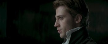 Movie still from “Lost Illusions” (2021), directed by Xavier Giannoli – A person wearing a suit and tie; Close Up shot, Low angle