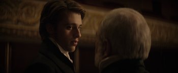 Movie still from “Lost Illusions” (2021), directed by Xavier Giannoli – A young man and an older man in a room; Close Up shot, Over the shoulder angle