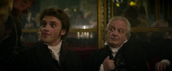 Movie still from “Lost Illusions” (2021), directed by Xavier Giannoli – Two men sitting next to each other in a room; Close Up shot, Over the shoulder angle