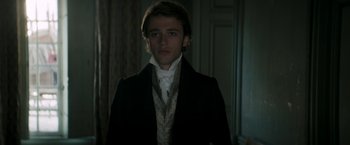 Movie still from “Lost Illusions” (2021), directed by Xavier Giannoli – A young man in a black jacket and a white shirt; Close Up shot, Over the shoulder angle