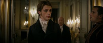 Movie still from “Lost Illusions” (2021), directed by Xavier Giannoli – A man in a black jacket standing next to a man in a white shirt; Close Up shot, Over the shoulder angle