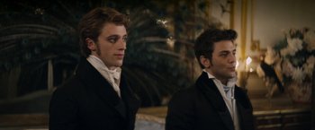 Movie still from “Lost Illusions” (2021), directed by Xavier Giannoli – Two men dressed in black suits standing next to each other; Close Up shot, Over the shoulder angle