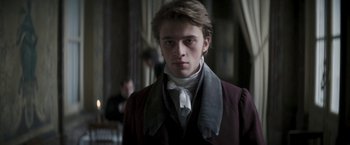 Movie still from “Lost Illusions” (2021), directed by Xavier Giannoli – A young man in a suit and a tie; Close Up shot, Low angle