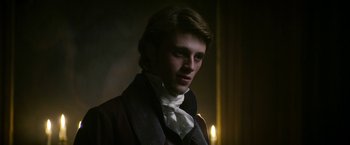 Movie still from “Lost Illusions” (2021), directed by Xavier Giannoli – A young man in a suit and a white tie; Close Up shot, Low angle