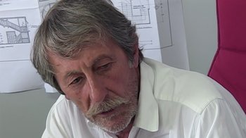 Movie still from “Lost in La Mancha” (2002), directed by Louis Pepe – An older man sitting in front of a drawing; Close Up shot, Low angle