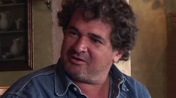 Movie still from “Lost in La Mancha” (2002), directed by Louis Pepe – A person with curly hair; Close Up shot, Low angle