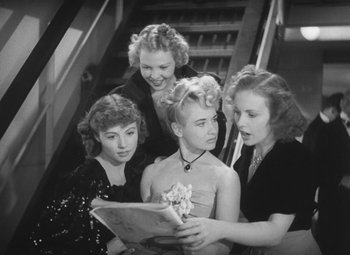 Movie still from “Love Affair” (1939), directed by Leo McCarey – A group of young women standing next to each other; Medium shot, High angle
