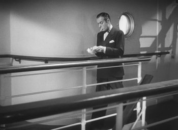 Movie still from “Love Affair” (1939), directed by Leo McCarey – A black and white photo of a man standing on a boat; Medium shot, High angle