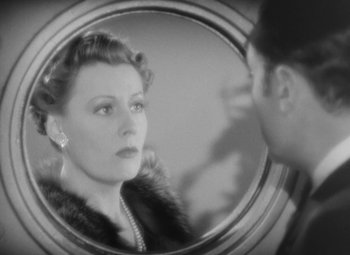 Movie still from “Love Affair” (1939), directed by Leo McCarey – A woman looking in the mirror while a man looks at her face; Close Up shot, Over the shoulder angle