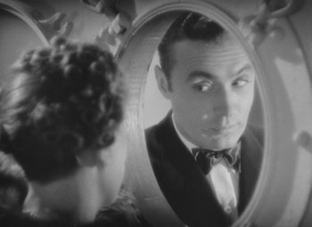 Movie still from “Love Affair” (1939), directed by Leo McCarey – A black and white photo of a man looking into a mirror; Close Up shot, Over the shoulder angle