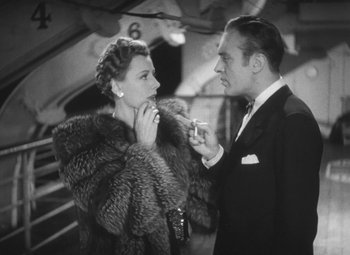 Movie still from “Love Affair” (1939), directed by Leo McCarey – A man and a woman are smoking a cigarette together; Medium shot, Low angle
