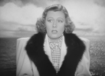 Movie still from “Love Affair” (1939), directed by Leo McCarey – An old black and white photo of a woman wearing a coat; Close Up shot, High angle