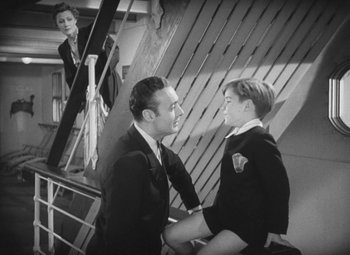 Movie still from “Love Affair” (1939), directed by Leo McCarey – A man and a woman sitting next to each other on stairs; Medium shot, High angle