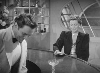 Movie still from “Love Affair” (1939), directed by Leo McCarey – A man and a woman sitting at a bar; Medium shot, Over the shoulder angle