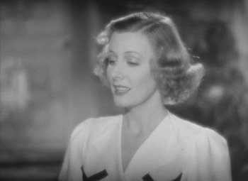 Movie still from “Love Affair” (1939), directed by Leo McCarey – A black - and - white photo of a woman in a white dress; Close Up shot, High angle