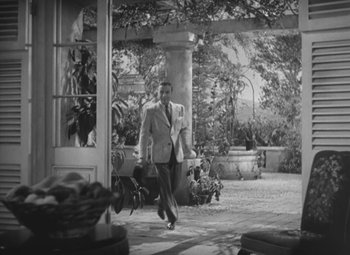 Movie still from “Love Affair” (1939), directed by Leo McCarey – A black and white photo of a man in a suit; Wide shot, Low angle