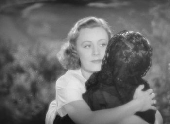 Movie still from “Love Affair” (1939), directed by Leo McCarey – An old black and white photo of a woman hugging a child; Close Up shot, High angle