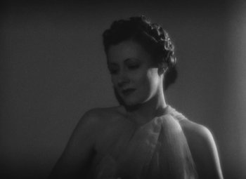 Movie still from “Love Affair” (1939), directed by Leo McCarey – A black and white photo of a woman in a dress; Close Up shot, Low angle