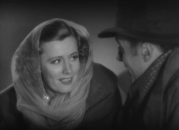 An old photo of a man and a woman talking to each other