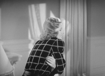 Movie still from “Love Affair” (1939), directed by Leo McCarey – A black - and - white photo of a woman in a checkered shirt; Medium shot, High angle