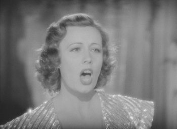 Movie still from “Love Affair” (1939), directed by Leo McCarey – An old photo of a woman singing in front of a microphone; Close Up shot, Low angle