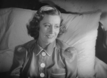 Movie still from “Love Affair” (1939), directed by Leo McCarey – An old photo of a woman smiling for the camera; Close Up shot, High angle