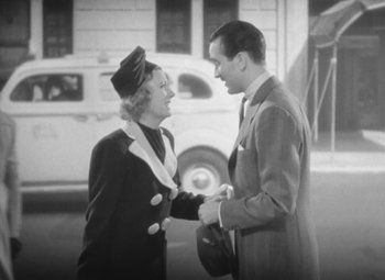 Movie still from “Love Affair” (1939), directed by Leo McCarey – An old photo of a man and a woman shaking hands; Medium shot, High angle