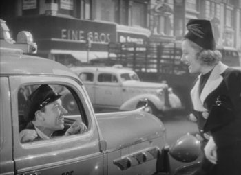 Movie still from “Love Affair” (1939), directed by Leo McCarey – An old photo of a man and a woman in a car; Medium shot, Over the shoulder angle