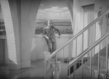 Movie still from “Love Affair” (1939), directed by Leo McCarey – A man standing on a balcony looking out at the sky; Wide shot, High angle