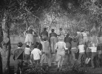 Movie still from “Love Affair” (1939), directed by Leo McCarey – A group of people standing on top of a wooden platform; Wide shot, High angle