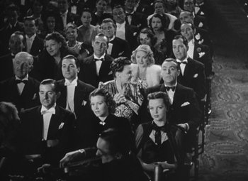 Movie still from “Love Affair” (1939), directed by Leo McCarey – A group of people sitting in a room together; Wide shot, High angle