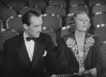 Movie still from “Love Affair” (1939), directed by Leo McCarey – A man and a woman sitting next to each other; Medium shot, Low angle