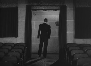 Movie still from “Love Affair” (1939), directed by Leo McCarey – A black and white photo of a man in a suit; Wide shot, Low angle