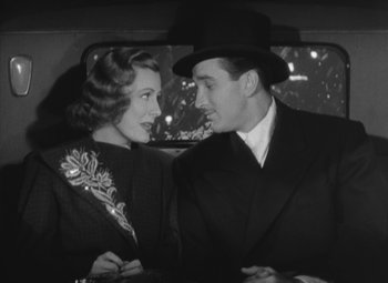 Movie still from “Love Affair” (1939), directed by Leo McCarey – A man and a woman in the back of a car; Medium shot, Low angle