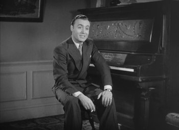 Movie still from “Love Affair” (1939), directed by Leo McCarey – A man sitting in front of a piano in a room; Medium shot, High angle