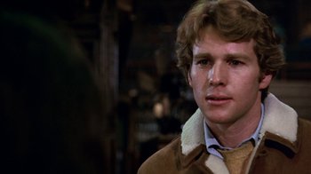 Movie still from “Love Story” (1970), directed by Arthur Hiller – A young man in a brown jacket and a tie; Close Up shot, Over the shoulder angle