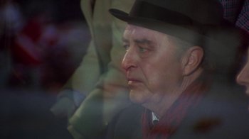 Movie still from “Love Story” (1970), directed by Arthur Hiller – An older man wearing a hat and a red shirt; Close Up shot, Over the shoulder angle