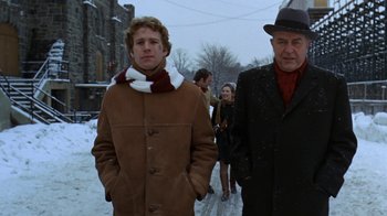 Movie still from “Love Story” (1970), directed by Arthur Hiller – A man and a woman walking down a snow covered sidewalk; Medium shot, Low angle